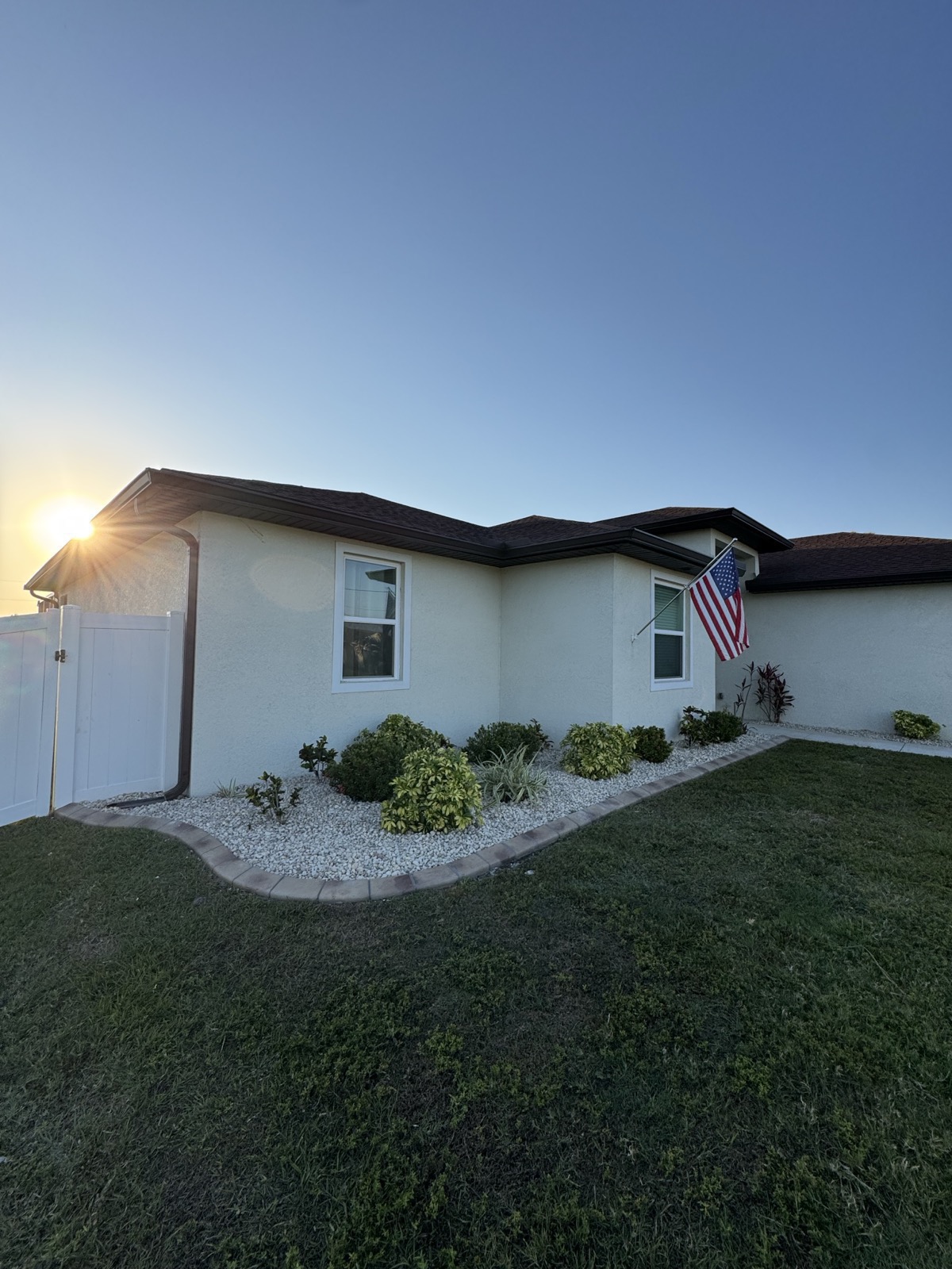 Beautiful North Port FL home with American flag and professionally manicured lawn by Moore Precision Lawn Care